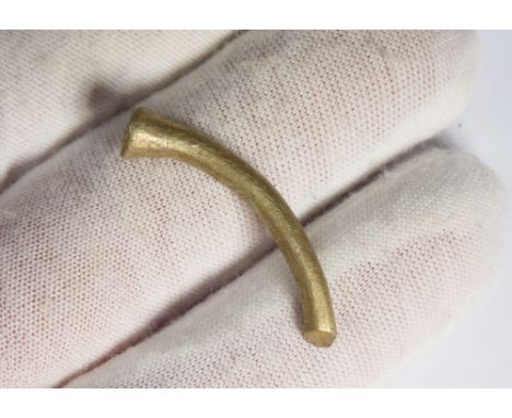 Bronze Age gold terminal. 1150-800 BCE. A fragment of a penannular bracelet formed of a circular sectioned piece of gold with