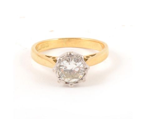 A diamond solitaire ring, the brilliant cut stone slightly illusion set in an 18 carat yellow and white gold mount, plain sha