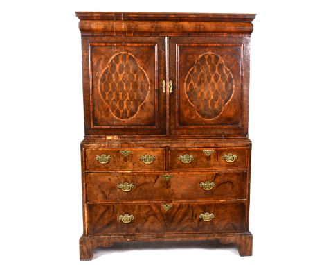 A Queen Anne laburnum and walnut cabinet, in part early 18th Century, moulded cornice over a cushioned frieze drawer, two pan