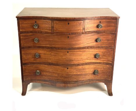 A George IV mahogany serpentine chest of drawers, with ebonised stringing, fitted with three short drawers over three long dr
