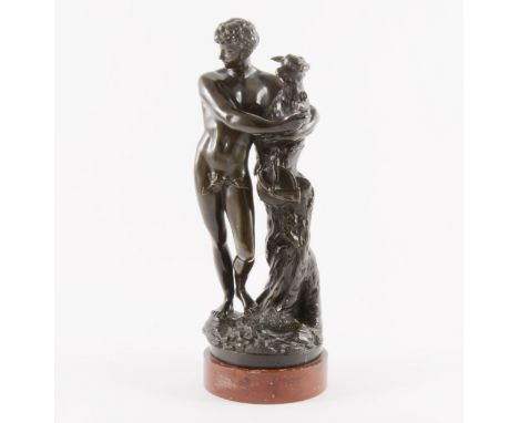 A French bronze model of a goatherd, 19th century, modelled with the standing figure with a kid, rouge marble circular plinth