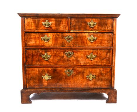 A George II walnut chest of drawers, with boxwood stringing, fitted with two short and three long drawers, panelled ends, bra
