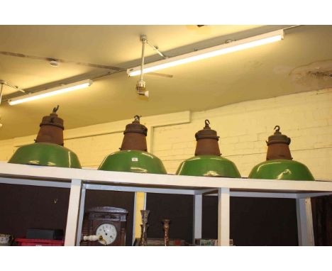 Set of four green industrial light fittings