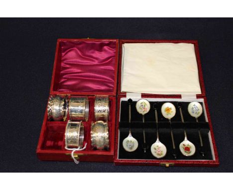 Collection of six silver napkin rings with engraved decoration and cased enamel on silver coffee spoons