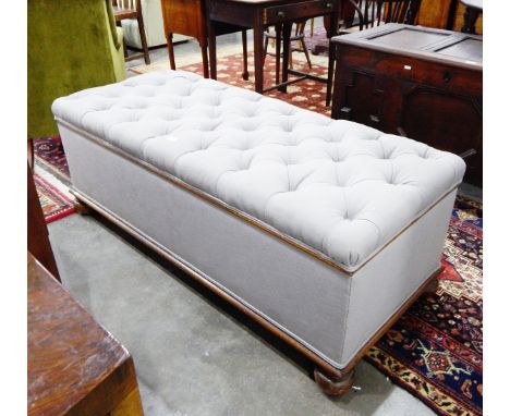 Early 20th century ottoman having deep button padded seat and on turned bun feet, 139cm wide 