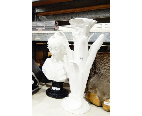 White ceramic stand in natural form of a lily supporting the white ceramic bust of a Victorian woman 