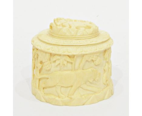 Early 20th century carved ivory cylindrical caddy/box with lion decoration to lid and lion hunting elephant frieze to sides, 