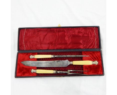 Three-piece steel carving set with ivory handles and white metal mounts, comprising carving knife and fork and steel, in orig