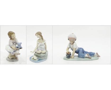 Lladro figurine of seated girl with teddy bear, a boy with train, and a girl by pond (3)