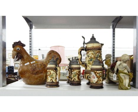 Large ceramic chicken, set of steins (one large and four others) featuring a bucolic cherub and a table ornament of young chi