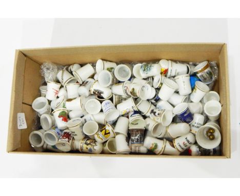 Quantity of decorative china ceramic thimbles including commemorative, souvenir, etc. and three wall-mounting racks 