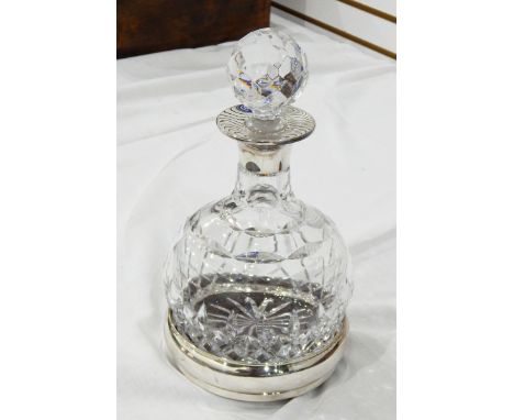 Cut glass and silver-mounted wine decanter with bulbous body and the facet-cut stopper and the matching silver wine coaster w