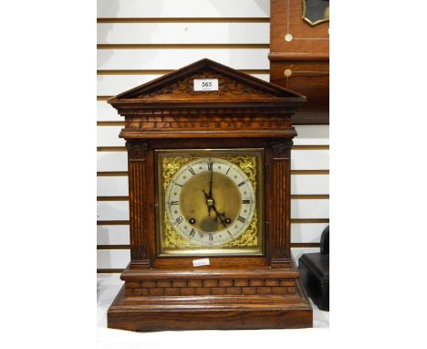 Late 19th century German mantel clock within architectural oak case, silvered chapter ring, eight-day striking movement, rais