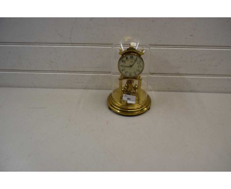 Kundo brass anniversary clock with floral decorated dial with Arabic numerals set under a glass dome, 23cm high