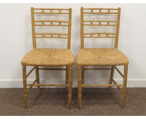 Pair Regency style ash simulated bamboo framed chairs, horizontal stick and ball back, rush seats