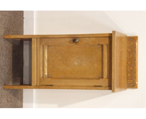 Early 20th century light oak cupboard enclosed by single panelled door, raised back relief carved with lunettes, W39cm, H84cm