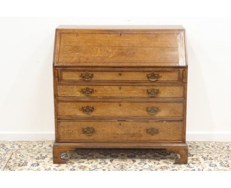 18th century oak bureau, sloped fall front with walnut band enclosing well fitted interior including six drawers and pigeon h