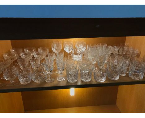 A Shelf full of Edinburgh & Stuart crystal whisky, wine & sherry glasses 