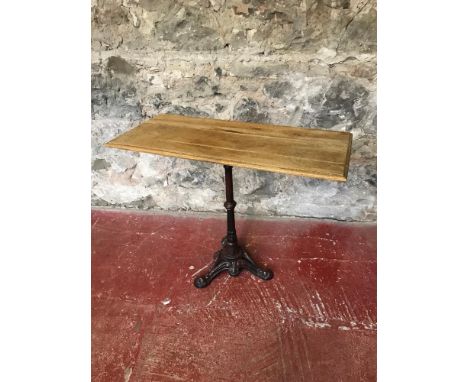 Cast iron base with light oak top garden table. 