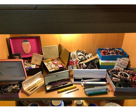 A Shelf full of costume jewellery, brooches, Vintage and modern pens which includes Sheaffer , Also includes possible silver 