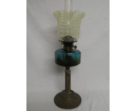 An Edwardian brass oil lamp with fluted column, blue tinted glass reservoir and opaline glass shade (shade in good condition)