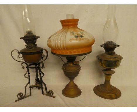 A brass oil lamp with opaque floral shade (af), brass oil lamp in metal stand and one other brass oil lamp (3)