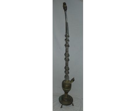 A Middle Eastern hookah pipe adapted as a standard lamp with floral and geometric decoration