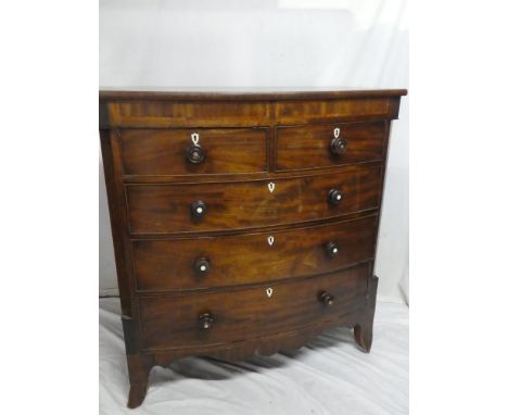 A mid 19th Century mahogany bow front chest of two short and three long drawers with turned handles on bracket feet