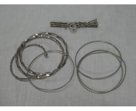 A selection of various silver bangles, silver gate link bracelet, etc
