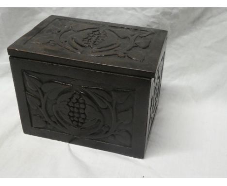 A 19th Century carved oak rectangular tea caddy with grape and leaf decoration and internal compartment