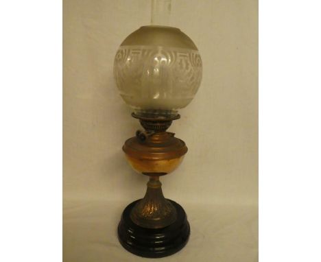 A Victorian/Edwardian copper oil lamp with leaf decorated stem and etched glass shade