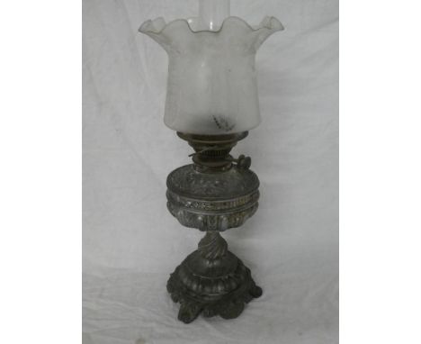 A Victorian spelter oil lamp with raised decoration and detachable reservoir with etched glass shade (shade with tiny base ch