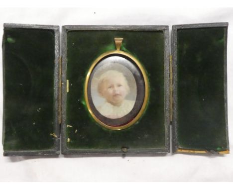 A miniature watercolour on ivory depicting bust portrait of a young child, 2" x 1½" oval in gilt locket frame and velvet line