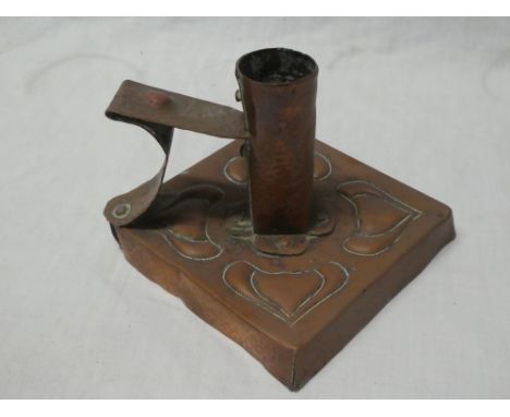 A Newlyn copper square chamber candlestick with raised leaf decoration, 4" wide