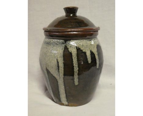 A Leach Studio pottery brown glazed circular jar and cover signed "JC", 9" high