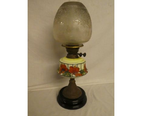 An Edwardian brass oil lamp with opaque glass poppy decorated reservoir and etched glass shade (shade in good condition)
