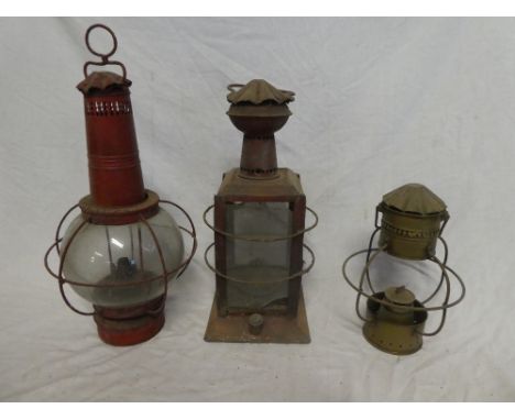 Two old painted metal nautical-style oil lamps and a brass part nautical oil lamp (3)