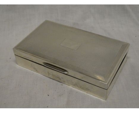 A good quality silver rectangular cigarette box with engine turned hinged lid, Birmingham marks 1967