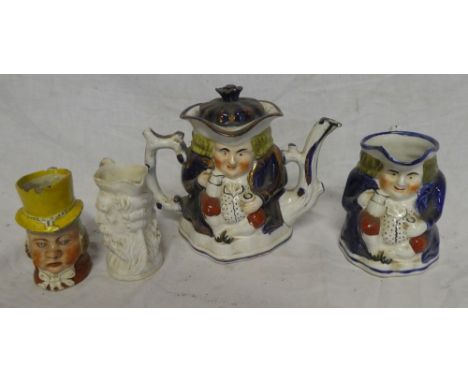 An old Staffordshire pottery Toby teapot with similar milk jug, 19th Century Staffordshire character jug "Paul Pry" and one o