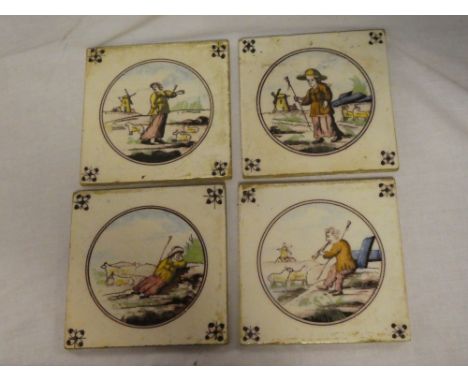 A set of four Dutch ceramic square tiles depicting labourer figures