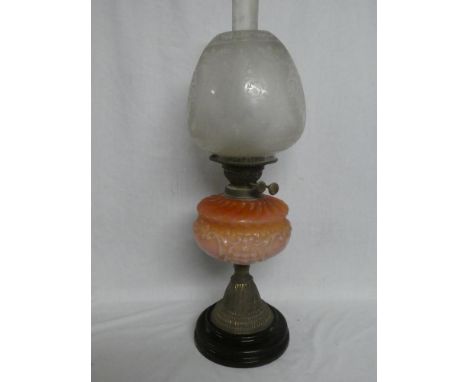 A Victorian brass oil lamp with pink-tinted glass scroll reservoir and etched glass shade (shade in good condition)