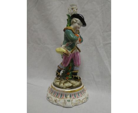 A German porcelain candlestick in the form of a young boy with rabbit on circular base, 11" high