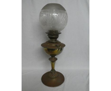 An Edwardian brass oil lamp with pedestal column and etched brass shade