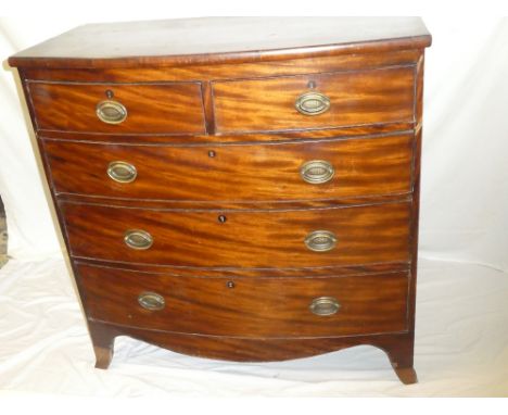 A mid 19th Century mahogany bow front chest of two short and three long drawers with brass ring handles on bracket feet