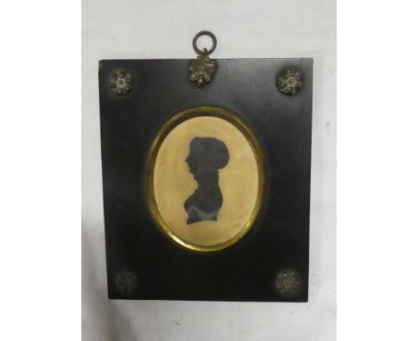 A 19th Century miniature silhouette depicting a bust portrait of a female, 3½" x 2½" oval in ebonised and brass mounted frame