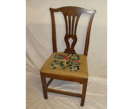 An early 19th Century oak country-style dining chair with pierced vase splat back and tapestry seat on square legs