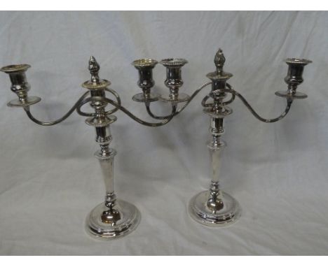 A pair of silver plated three branch candelabra with adjustable stems, the base engraved "Lt. Cl. G.M.G. Atkins RA from the O