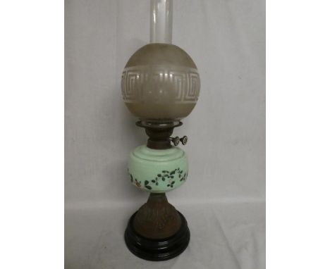 A Victorian brass oil lamp with green tinted opaque glass floral reservoir and etched glass shade