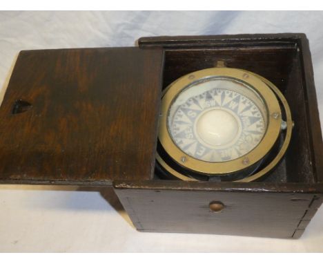 A brass liquid boat compass, 5" diameter in stained wood box with gimbled mount
