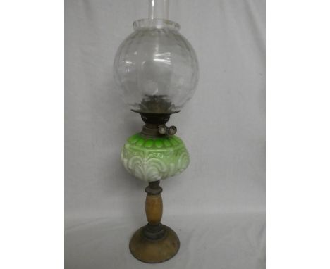 An Edwardian brass oil lamp with alabaster mounted stem, green opaque glass reservoir and clear glass shade